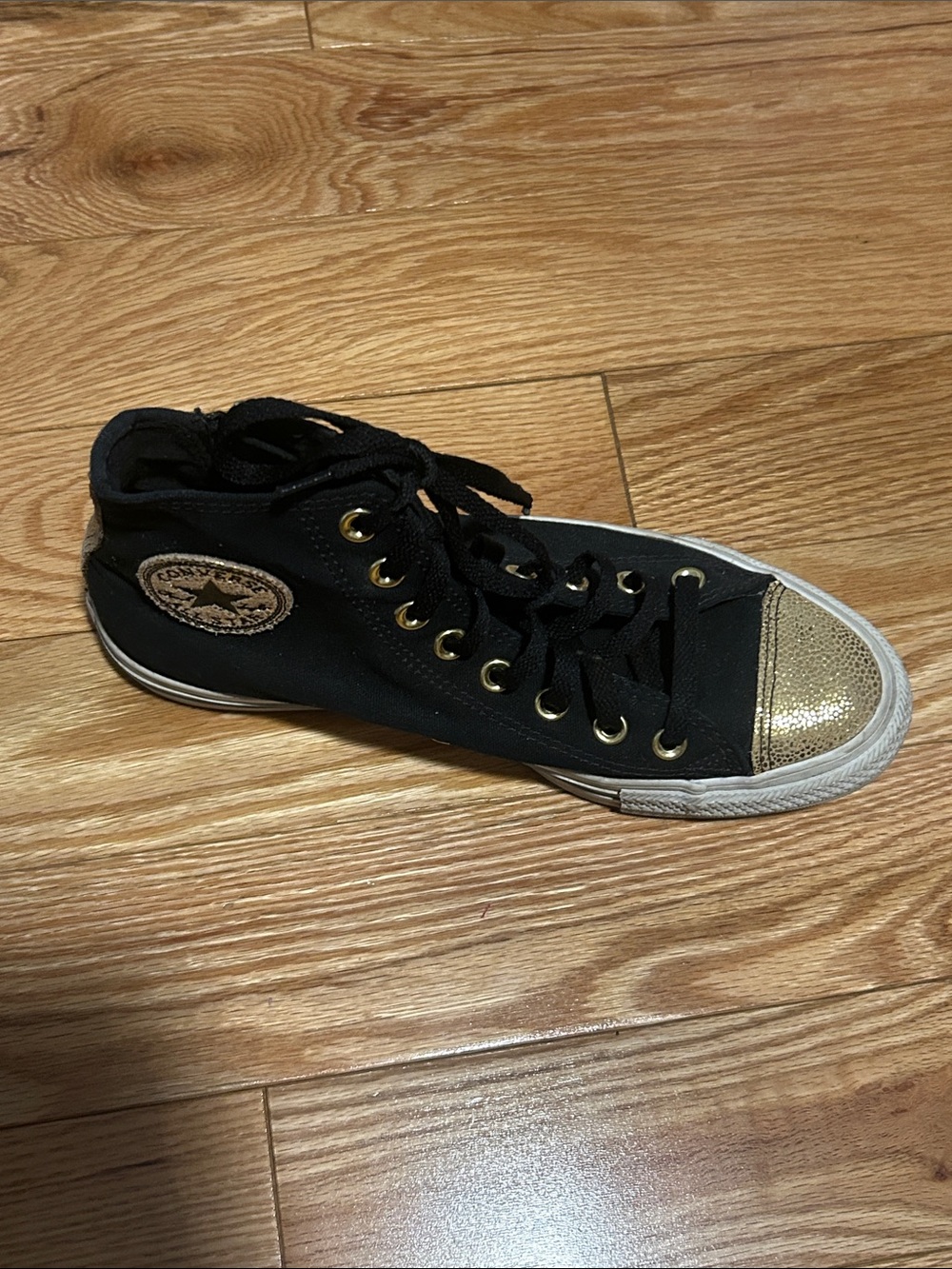 Black High-Top all star converse with Gold Metallic Toe and Eyelet Accents